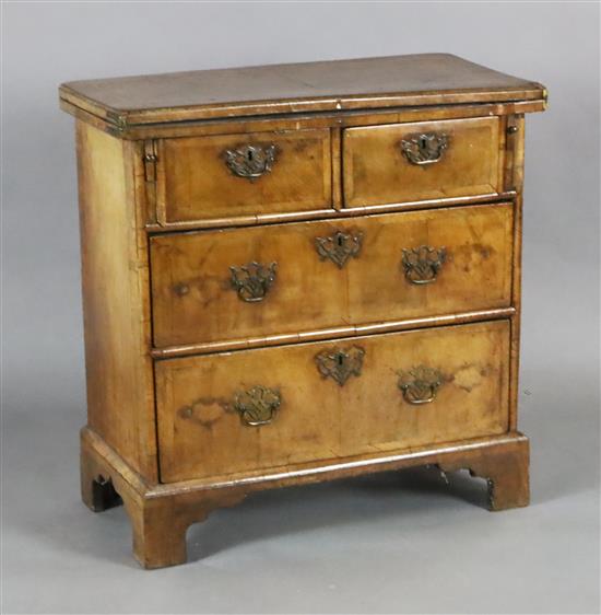 An early 18th century style crossbanded walnut bachelors chest, W.2ft 4in. D.1ft 2in. H.2ft 4.5in.